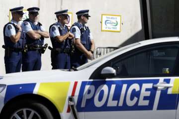 Police keep watch outside Friday prayers at an arena in Christchurch, New Zealand, Friday, March 13,