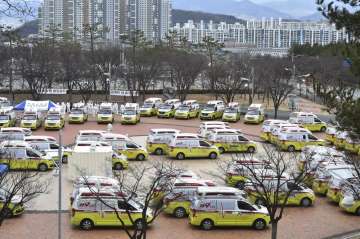 Ambulances are parked to transport patients with mild symptoms of the coronavirus in Daegu, South Ko