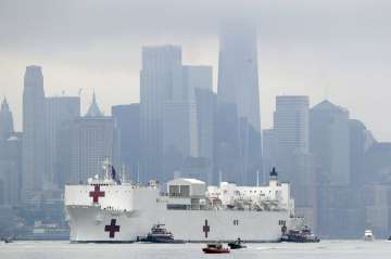 The Navy hospital ship USNS Comfort passes lower Manhattan on its way to docking in New York, Monday