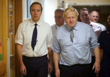 Britain's Prime Minister Boris Johnson, right, and Health Minister Matt Hancock visit Bassetlaw District General Hospital on their General Election campaign in Worksop, England. Matt Hancock has tested positive for the new coronavirus, Friday March 27, 2020, the same day as Prime Minister Boris Johnson was confirmed to have COVID-19.