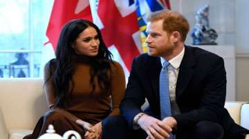 Prince Harry and Meghan get standing ovation in UK