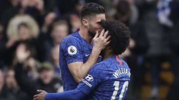 Chelsea's Olivier Giroud, left, celebrates with Chelsea's Willian after scoring his side's fourth goal during the English Premier League soccer match between Chelsea and Everton at Stamford Bridge stadium in London, Sunday, March 8