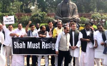 Congress MPs holding placards demanding the resignation of Union Home Minister Amit Shah, at Parliament House on Monday (Twitter)