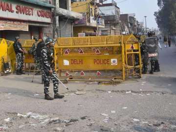 Police stand guard in a riot-affected locality of northeast Delhi last month (PTI file photo)