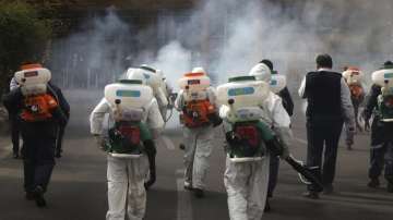 A file photo of health workers spraying disinfectants on the streets of Iran