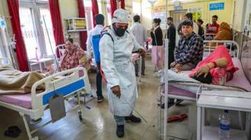 Sanitation worker sprays disinfectants inside a hospital in Jammu earlier this month