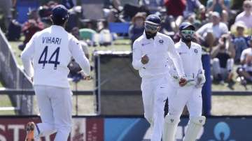 India's Virat Kohli, centre, reacts after taking a catch to dismiss New Zealand's Henry Nicholls during play on day two of the second cricket test between New Zealand and India at Hagley Oval in Christchurch, New Zealand, Sunday, March 1