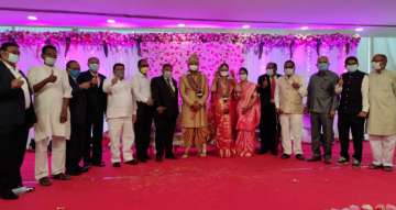 Couple ties knot with masks on; hand sanitisers, packaged food for guests