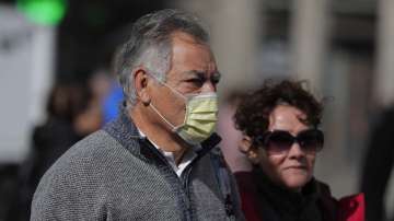 A man wears a face mask in central Madrid, Spain, Monday, March 9, 2020.