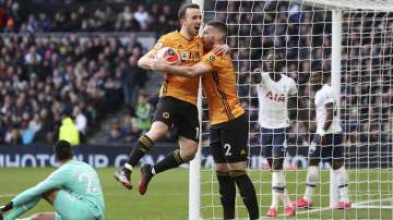 Wolverhampton Wanderers' Diogo Jota, center left, celebrates scoring his side's second goal of the game with teammate Matt Doherty during the English Premier League soccer match between Tottenham and Wolverhampton Wanderers at the Tottenham Hotspur Stadium