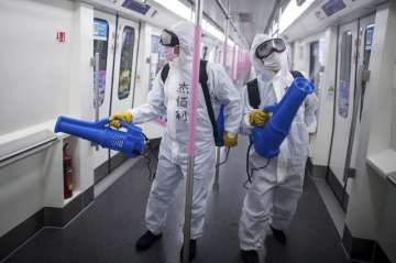 Healthcare workers in China disinfecting a metro train (file photo)