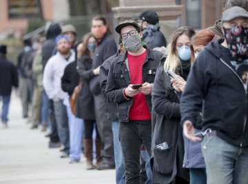 People line up to vote at Riverside High School during the primary in Milwaukee on Tuesday, April 7,