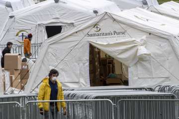 A Samaritan's Purse crew and medical personnel work on preparing to open a 68 bed emergency field ho