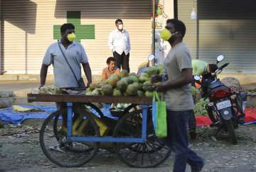 Indians shop for vegetables during lockdown in Bangalore, India, Thursday, March 26, 2020. The unpre