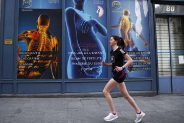 French IT consultant, Amelie Desroziers, 25, goes jogging for her daily one hour exercise during a n