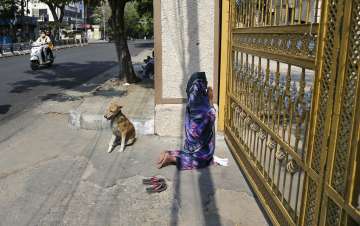 An Indian woman offers Easter prayers from outside the closed gates of Saint Mary's Basilica in Hyde