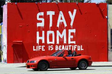 A mural reads "Stay Home, Life is Beautiful' Tuesday, April 14, 2020, in Los Angeles. Murals with th