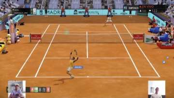 A screen grab taken on Monday April 27, 2020 showing Spain's Rafael Nadal, bottom left, playing against Canada's Denis Shapovalov, bottom right, in a "virtual" tennis match at a tournament hosted by the Madrid Open. Tennis has joined the video game craze taking over the sports world during the coronavirus pandemic, with Rafael Nadal, Andy Murray and 30 other pros trading in their rackets for controllers this week to participate in a "virtual" tournament hosted by the Madrid Open.