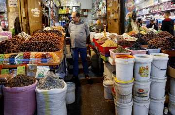 Ramadan 2020 muslim festival: A vendor waits for customers to buy traditional food Gaza