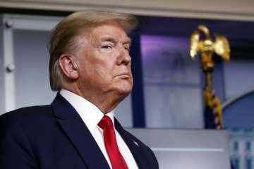 President Donald Trump listens as Agriculture Secretary Sonny Perdue speaks about the coronavirus in