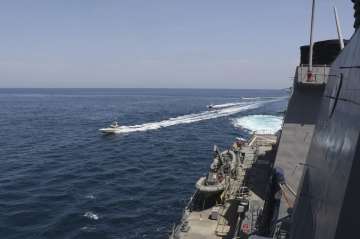  Iranian Revolutionary Guard vessels sail close to U.S. military ships in the Persian Gulf near Kuw