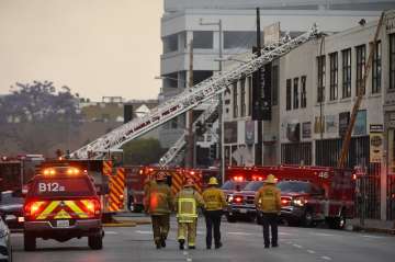 Los Angeles Fire Department firefighters work the scene of a structure fire that injured multiple fi