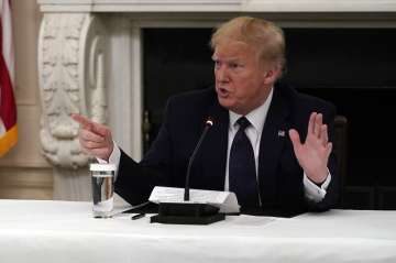 President Donald Trump tells reporters that he is taking zinc and hydroxychloroquine during a meetin