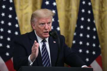  President Donald Trump answers questions from reporters during a event about protecting seniors, in