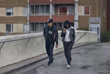 A young couple walks along a bridge in Rinkeby-Kista borough in Stockholm, Sweden, Tuesday, April 28