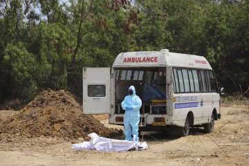 A Muslim priest in protective gear offers funeral prayers for a Central Reserve Police Force (CRPF) 