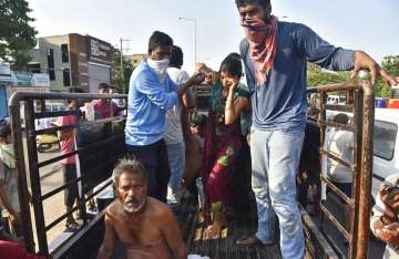 People affected by a chemical gas leak are carried out of a truck to an ambulance in Vishakhapatnam