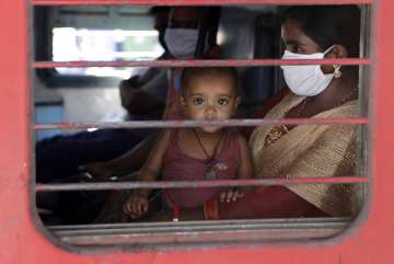 A child looks on as a special train transporting migrant workers to Bihar leaves Thane, in the weste