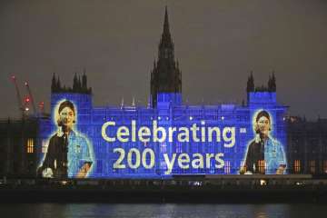 An image of Florence Nightingale is projected on the Houses of Parliament in Westminster, London, on