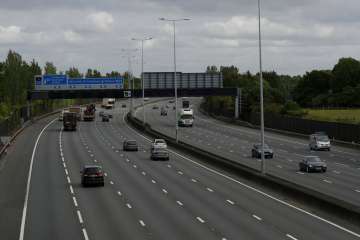 Traffic passes along the M25 London orbital motorway at just before 09:15am local time, near the tow