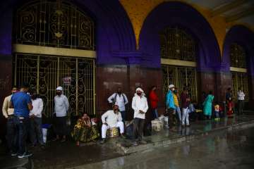 Stranded passengers wait outside Howrah railway station closed due to coronavirus lockdown in Kolkat