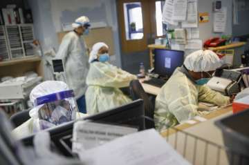 In this Monday, April 20, 2020 file photo, emergency room doctors and nurses wear personal protectiv