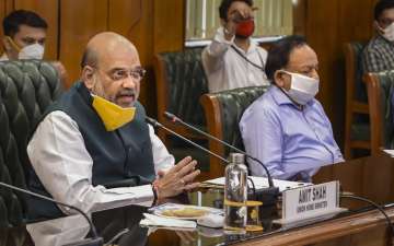 New Delhi: Union Home Minister Amit Shah with Health Minister Harsh Vardhan (R) holds a meeting to discuss the COVID-19 situation in Delhi, at North Block in New Delhi, Sunday, June 14, 2020. The meeting comes in the wake of increasing number of coronavirus cases in Delhi, where the tally has reached nearly 39,000 cases and the death toll rose to over 1,200. (PTI Photo/ Shahbaz Khan)