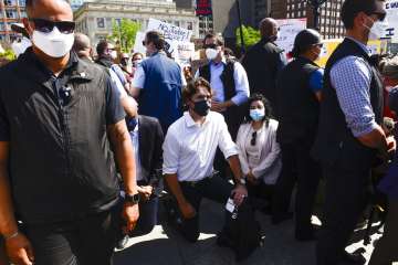 Prime Minister Justin Trudeau takes a knee as he takes part in an anti-racism protest on Parliament 