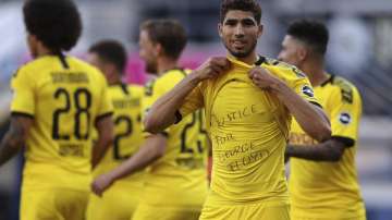 Achraf Hakimi Mouh of Borussia Dortmund celebrates scoring his teams fourth goal of the game with a 'Justice for George Floyd' shirt during the German Bundesliga soccer match between SC Paderborn 07 and Borussia Dortmund at Benteler Arena in Paderborn