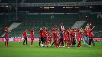 Players of Bayern Munich celebrate securing the Bundesliga title in front of empty stands following their victory in the Bundesliga match between SV Werder Bremen and FC Bayern Muenchen at Wohninvest Weserstadion on June 16