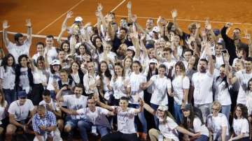 In this photo taken on Sunday, June 14, 2020, Serbia's Novak Djokovic, centre, poses with volunteers and players after the Adria Tour charity tournament in Belgrade