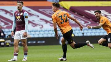 Wolverhampton Wanderers' Leander Dendoncker, center, celebrates after scoring the opening goal during the English Premier League soccer match between Aston Villa and Wolverhampton Wanderers at Villa Park in Birmingham