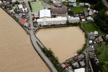 A schoolyard of a junior high school is seen flooded following heavy rains in Gero, Gifu prefecture,