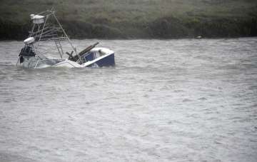  A boat sinks in the Packery Channel during Hurricane Hanna, Saturday, July 25, 2020, in North Padre