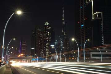 In this photo taken with a slow shutter speed, traffic speeds down the Sheikh Zayed Road in Dubai, United Arab Emirates, Monday, July 6, 2020. Dubai reopened for tourists Tuesday amid the coronavirus pandemic, hoping to reinvigorate a vital industry for this city-state before its crucial winter tourist season. (AP Photo/Jon Gambrell)