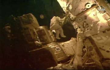 This photo provided by NASA shows astronauts Bob Behnken and Chris Cassidy on a spacewalk outside of the International Space Station on Tuesday, July 21, 2020. The astronauts are on their fourth and final spacewalk in under a month and instead of swapping batteries, they'll be routing cables and hooking up a tool storage chest.