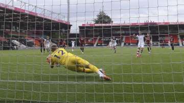 Bournemouth's goalkeeper Aaron Ramsdale saves a penalty during the English Premier League soccer match between Bournemouth and Southampton, at the Vitality Stadium in Bournemouth, England, Sunday, July 19