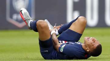 PSG's Kylian Mbappe shouts in pain after being tackled during the French Cup soccer final match between Paris Saint Germain and Saint Etienne at Stade de France stadium, in Saint Denis, north of Paris, Friday July 24