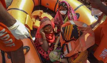 East Champaran: NDRF personnel hold a new-born baby on a rescue boat in the flood-affected East Champaran district of Bihar.