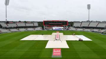 The pitch area is seen covered ahead of the fourth day of the third cricket Test match between England and West Indies at Old Trafford in Manchester, England, Monday.